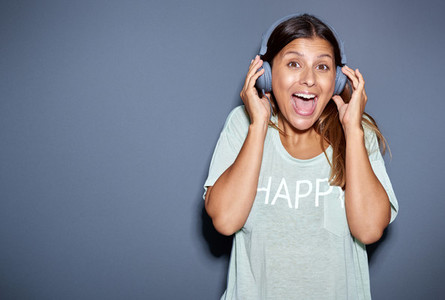Excited young woman listening to music