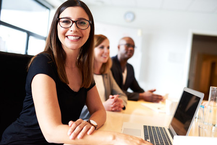 Young female executive smiling during meeting