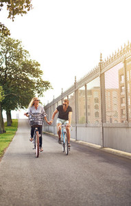Young couple cycling down a cycle lane
