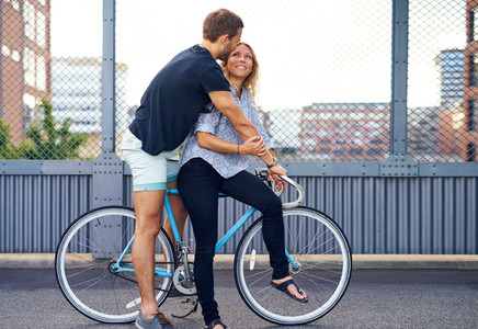 Sweet Young Couple on a Bicycle at the Street