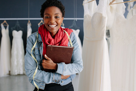 Female wedding fashion designer in a bridal boutique