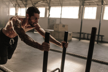 Man doing intense workout in gym
