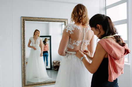 Wedding dress fitting in bridal boutique