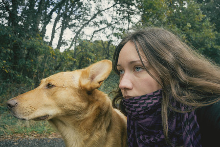 Dog and girl looking together