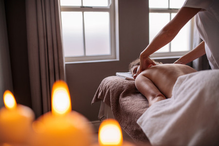 Professional beautician massaging female back