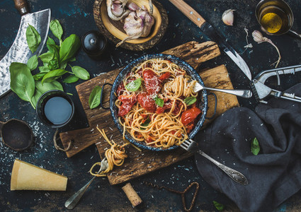 Spaghetti with tomato and basil and ingredients for making pasta