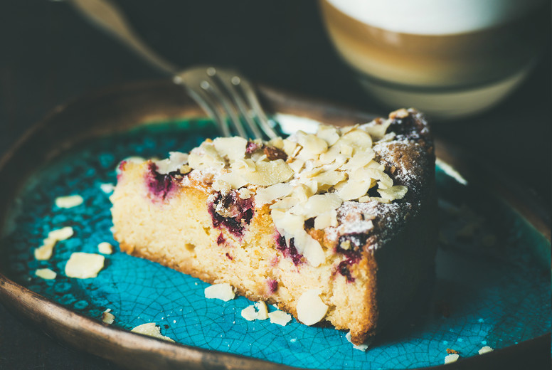 Piece of cake and glass of latte, square crop