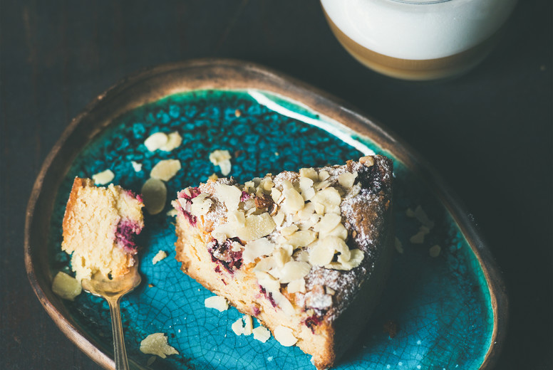 Piece of lemon, ricotta, almond, raspberry cake and coffee