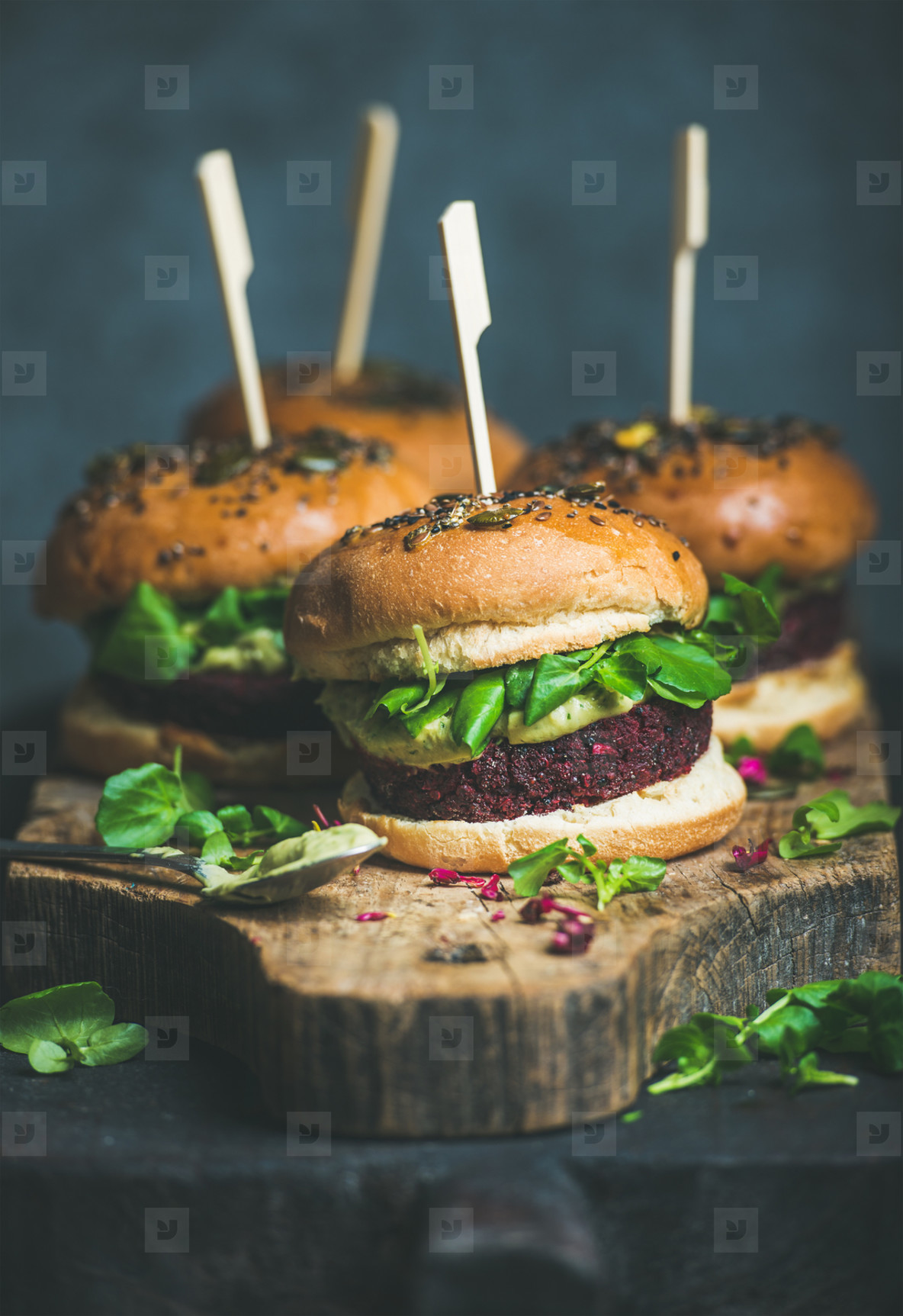 Healthy homemade vegan burger with beetroot quinoa patty  arugula  avocado sauce