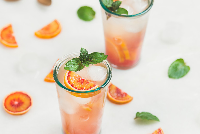Blood orange fresh lemonade with ice and mint, square crop