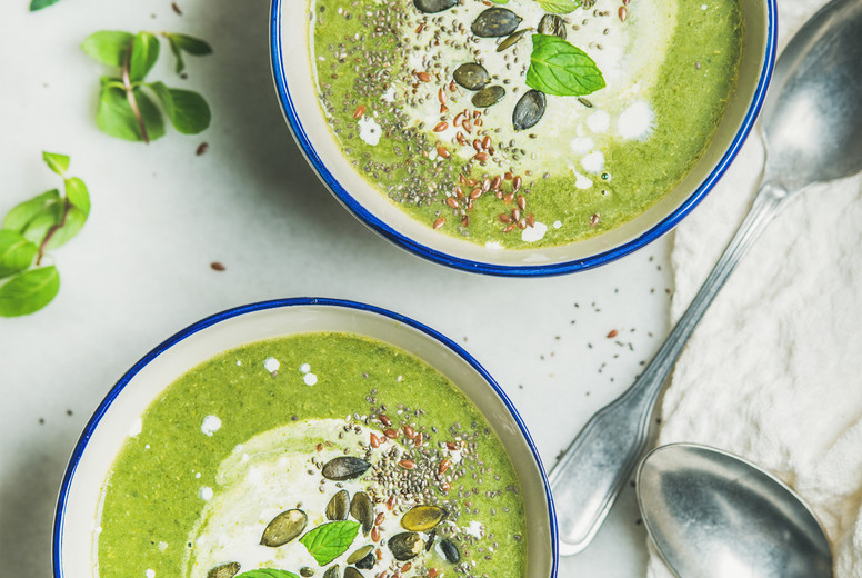 Spring broccoli cream soup with fresh mint and coconut cream