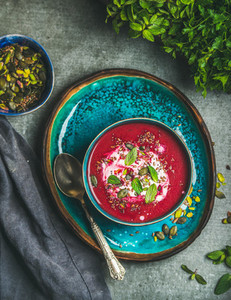 Spring beetroot soup with mint leaves and seeds top view