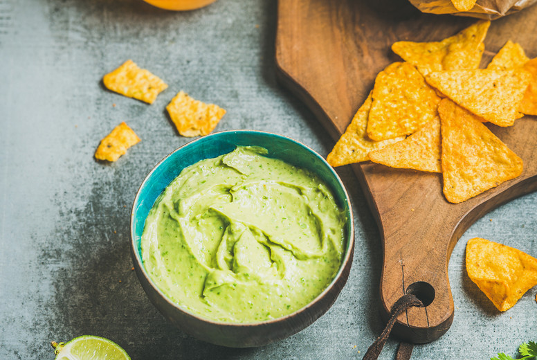 Mexican corn chips, fresh guacamole sauce and beer, square crop