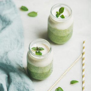 Ombre layered green smoothies with mint in jars  square crop