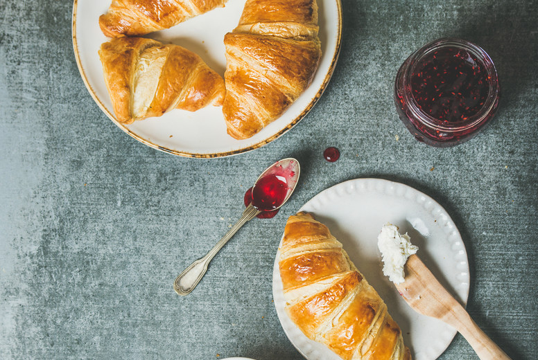 Croissants with jam, cream-cheese and milk in bottle, square crop