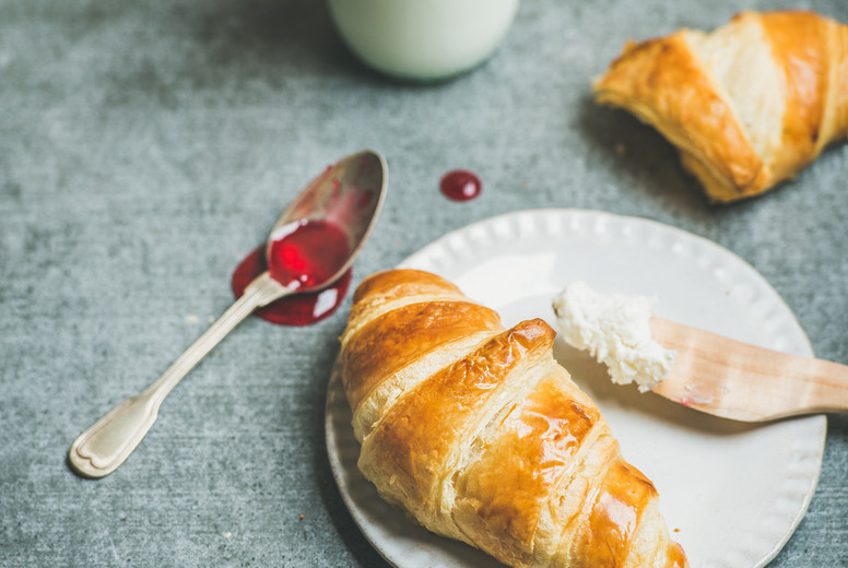 Croissants with raspberry jam, ricotta cheese and milk, copy space