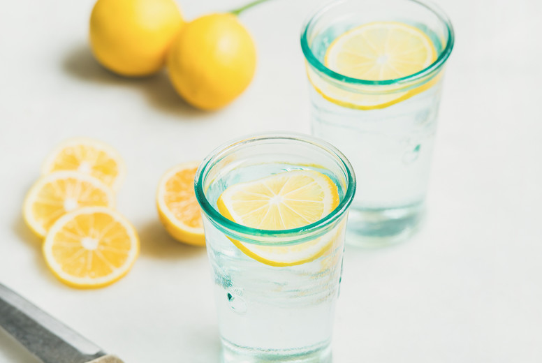 Morning detox lemon water in glasses, square crop