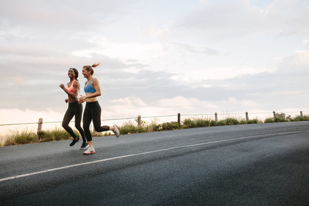 Two women athletes running