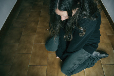 sad girl kneeling on the floor