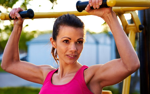 Woman smiling while lifting weights