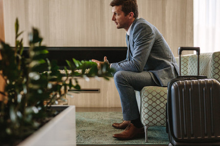 Businessman eagerly waiting for this flight