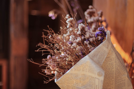Soft focus of dried flowers in newspaper wrap for decoration