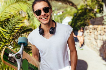 Handsome young man on vacation with longboard