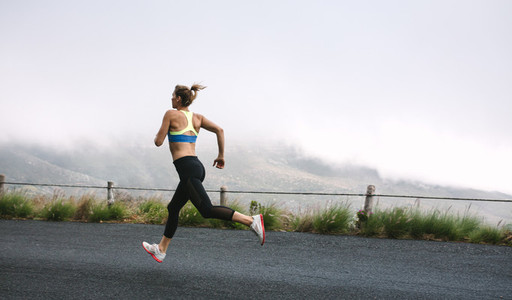 Woman athletes running on road