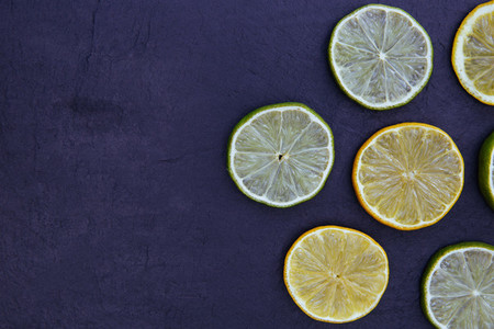 Lemon lime slices food on dark background