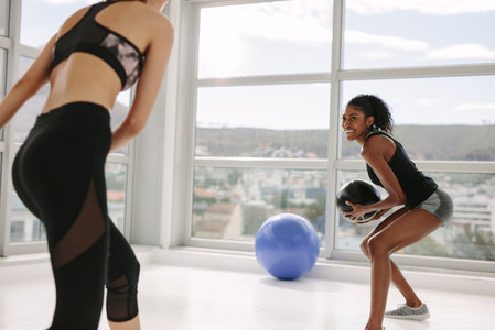 Females exercising with medicine ball
