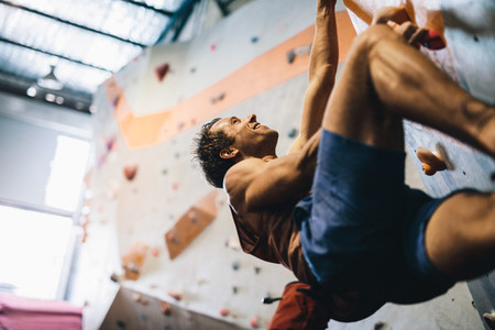 Man climbing indoor boulder wall