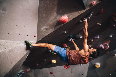 Man climbing indoor boulder wall