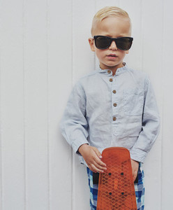 Serious small boy in modern sunglasses