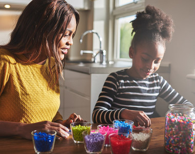 Mother and daughter creating beaded crafts