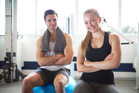 Young Fit Couple Inside the Gym Smiling at Camera