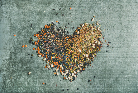 Various raw grains  beans and cereals in shape of heart