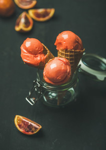 Refreshing summer blood orange ice cream in sweet waffle cones