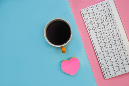 Minimal computer keyboard love heart on bright blue background