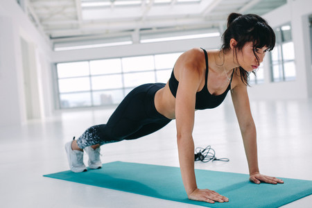 Fit and strong woman doing push ups
