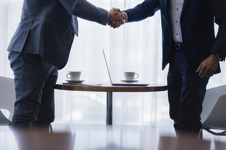 Businessmen shaking hands after successful meeting