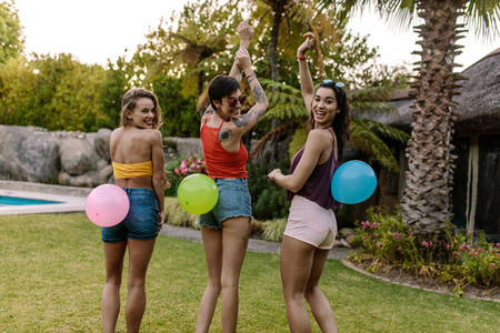 Group of friends playing balloon pop game