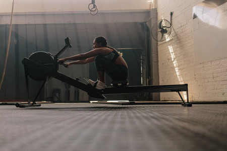 Female athlete using rowing machine
