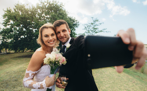 Wedding couple taking a selfie