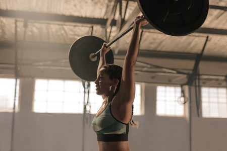 Female athlete lifting heavy weights