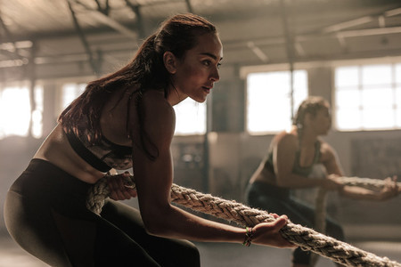 Women exercising with rope at a gym