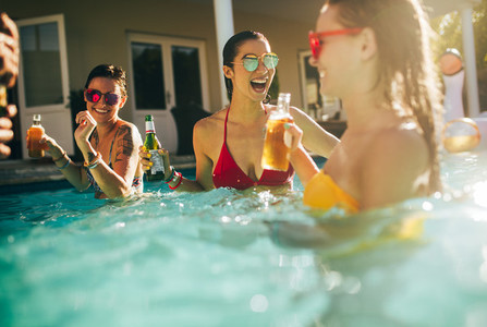 Group of women having party in a swimming pool