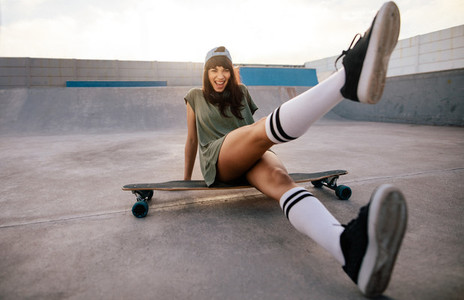 Female skateboarder having fun at skate park