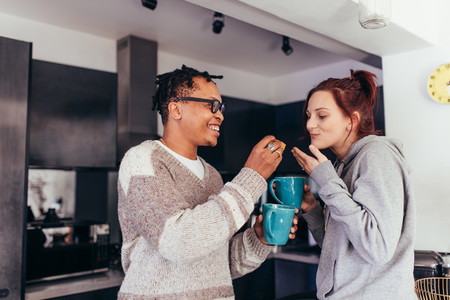 Interracial couple having coffee together in morning