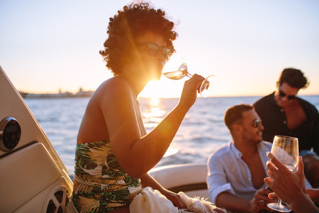 African woman partying with friends in boat