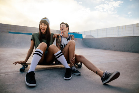 Female skaters friends hangout at skate park